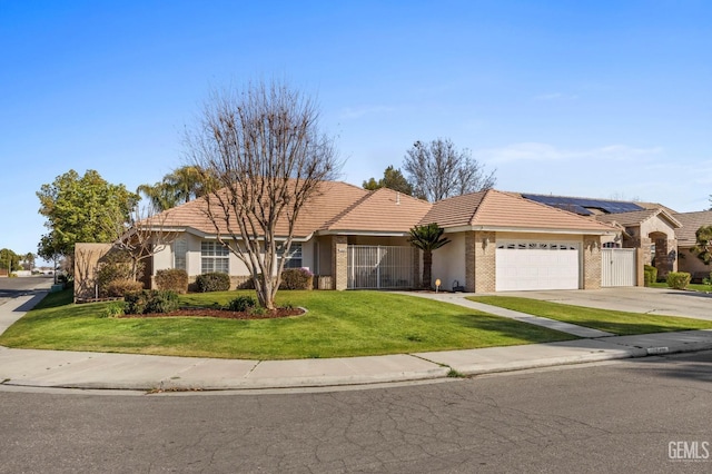 single story home with a garage, solar panels, driveway, stucco siding, and a front yard