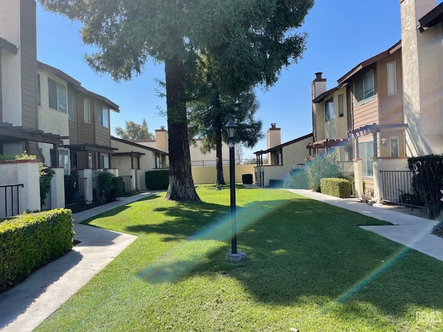 view of home's community featuring a lawn