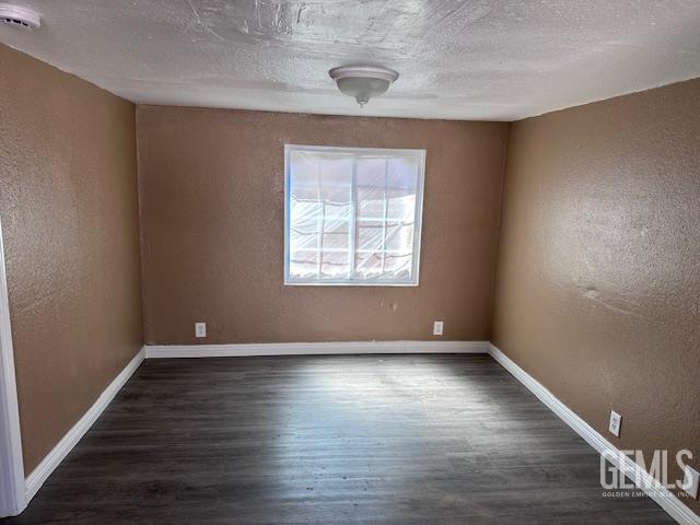 780 Mayer Ln, Bakersfield, CA 93263 - empty room featuring wood finished floors, a textured wall, a smoke detector, baseboards, and a textured ceiling
