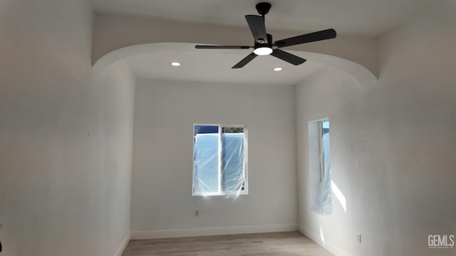 empty room with light wood-type flooring and ceiling fan