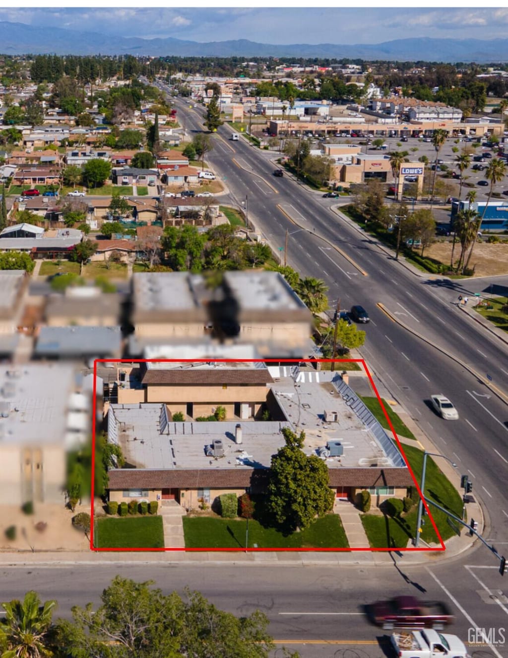 1500 Columbus St, Bakersfield, CA 93305 - aerial view of property and surrounding area with property boundaries highlighted and a mountain backdrop