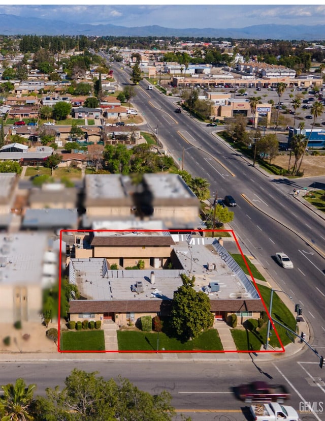 1500 Columbus St, Bakersfield, CA 93305 - aerial view of property and surrounding area with property boundaries highlighted and a mountain backdrop