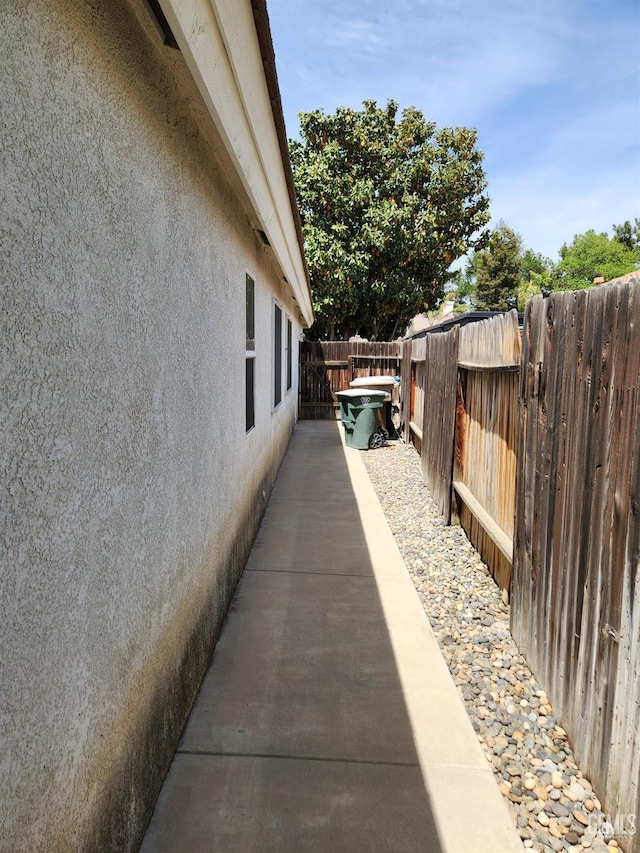 8707 Beau Maison Way, Bakersfield, CA 93311 - view of property exterior with stucco siding and a fenced backyard