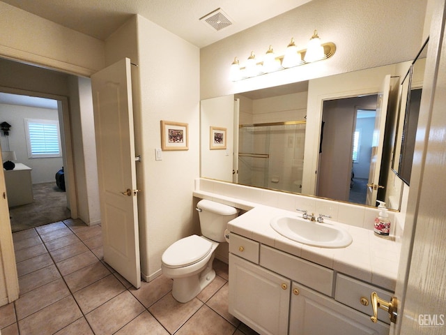 8707 Beau Maison Way, Bakersfield, CA 93311 - full bath featuring a shower with door, toilet, tile patterned floors, and vanity