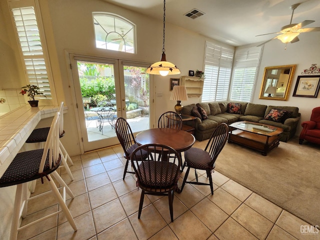 8707 Beau Maison Way, Bakersfield, CA 93311 - dining room with light tile patterned floors, ceiling fan, light carpet, and french doors
