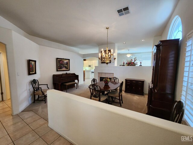 8707 Beau Maison Way, Bakersfield, CA 93311 - dining area with light carpet, light tile patterned flooring, plenty of natural light, a chandelier, and recessed lighting
