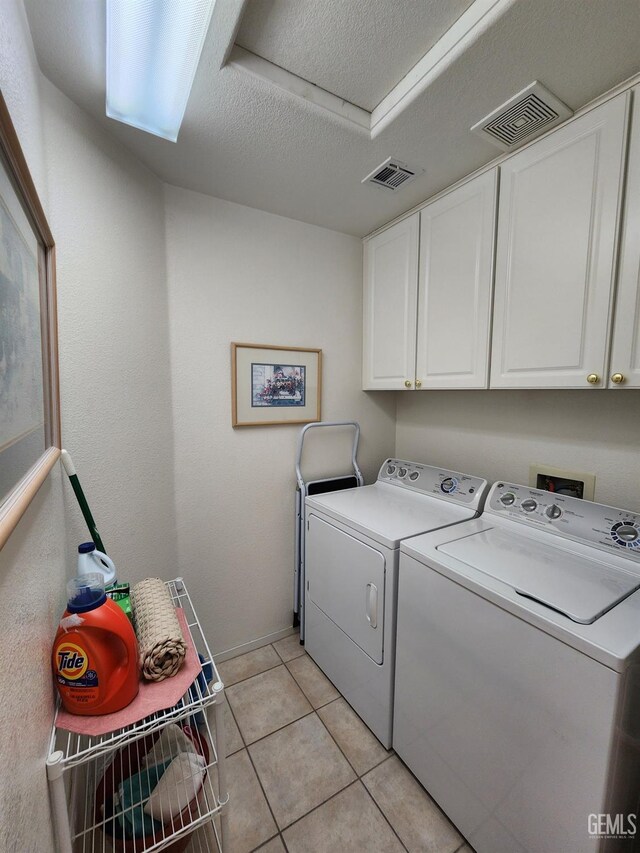8707 Beau Maison Way, Bakersfield, CA 93311 - washroom with cabinet space, washer and dryer, light tile patterned flooring, and baseboards