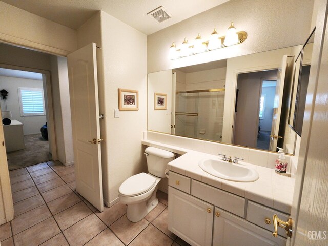 8707 Beau Maison Way, Bakersfield, CA 93311 - full bath featuring a shower with door, toilet, tile patterned floors, and vanity