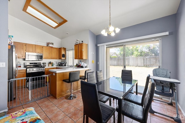 7507 Hidden Bridge Dr, Bakersfield, CA 93313 - kitchen with stainless steel appliances, lofted ceiling, healthy amount of natural light, light countertops, and a chandelier