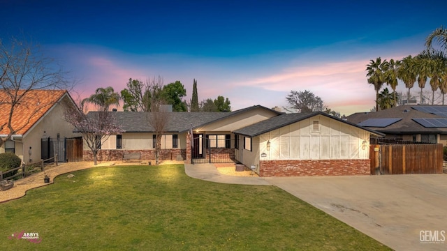 view of front of home with driveway, a front yard, and fence