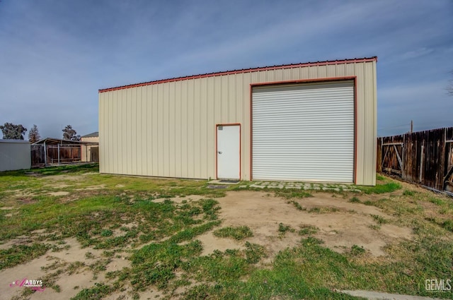 detached garage featuring fence