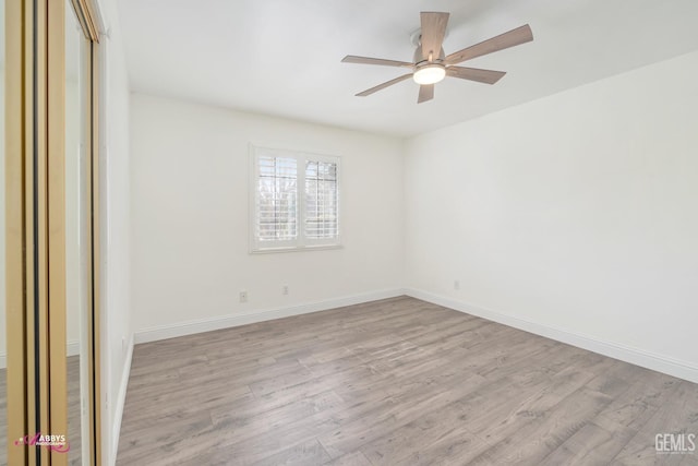 unfurnished room with light wood-style flooring, baseboards, and a ceiling fan