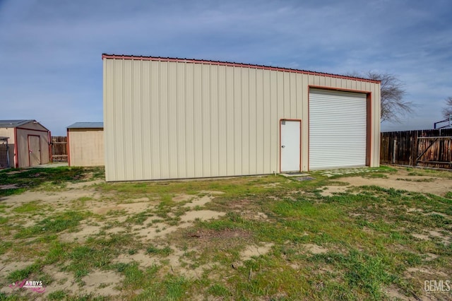 view of outbuilding with an outbuilding and fence