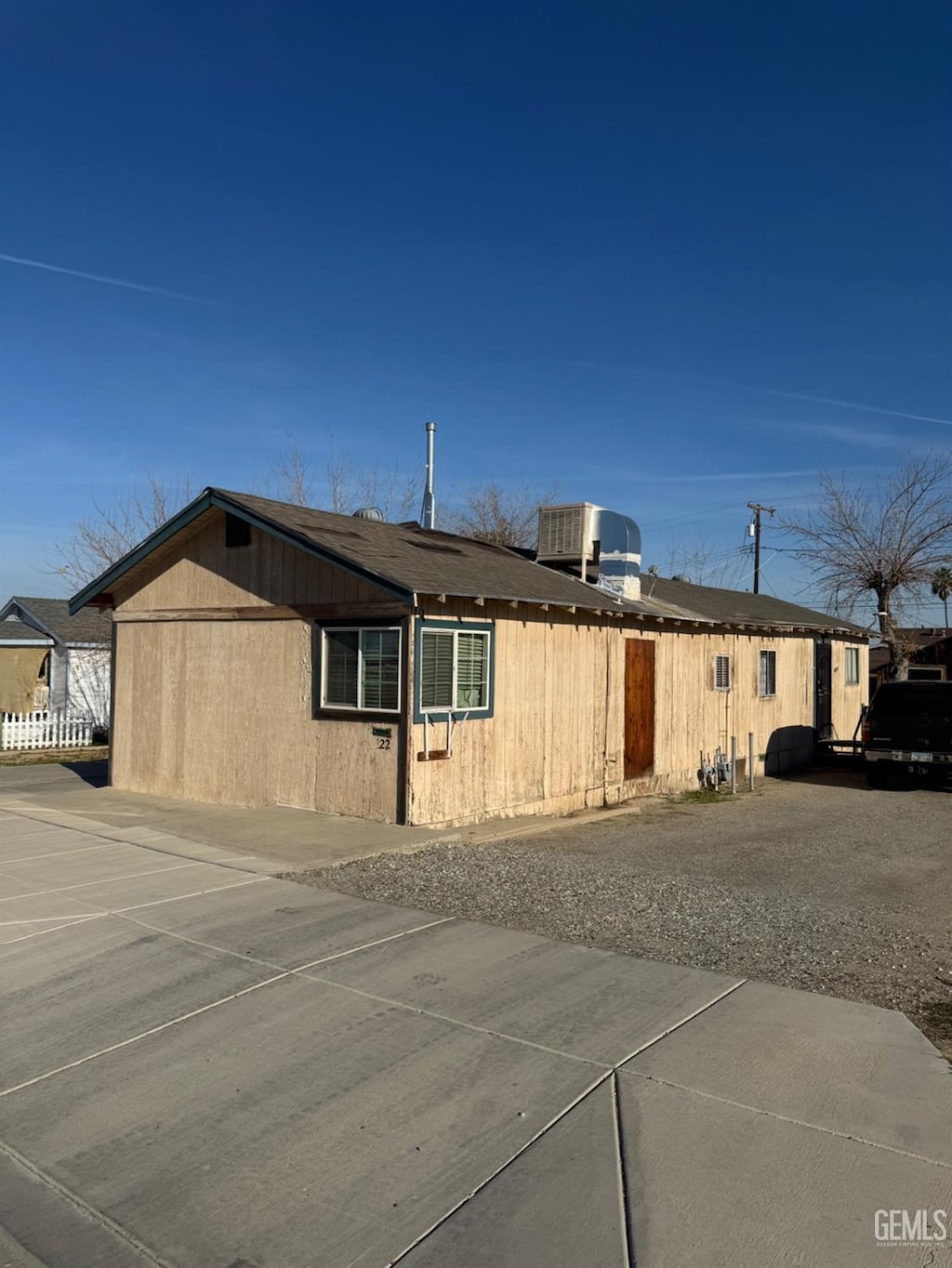 view of side of home with central AC unit