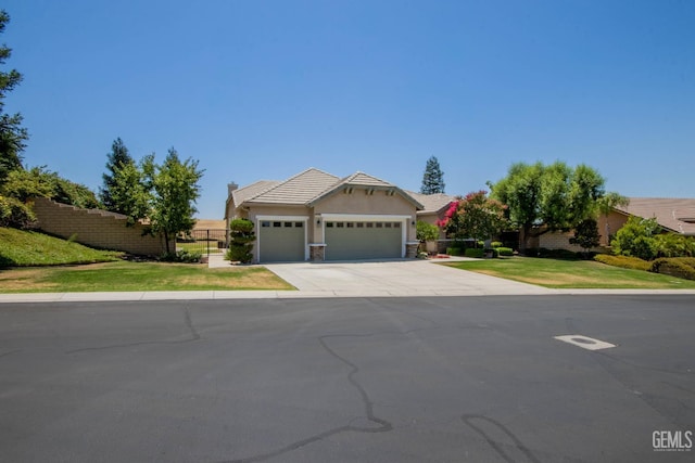 15101 Via Napoli Dr, Bakersfield, CA 93306 - view of front facade featuring a garage, driveway, and stucco siding