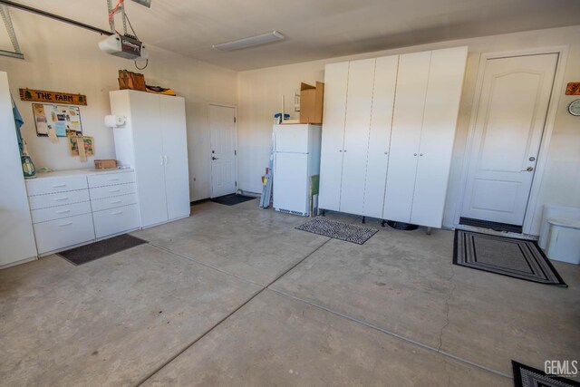 15101 Via Napoli Dr, Bakersfield, CA 93306 - garage with freestanding refrigerator and a garage door opener