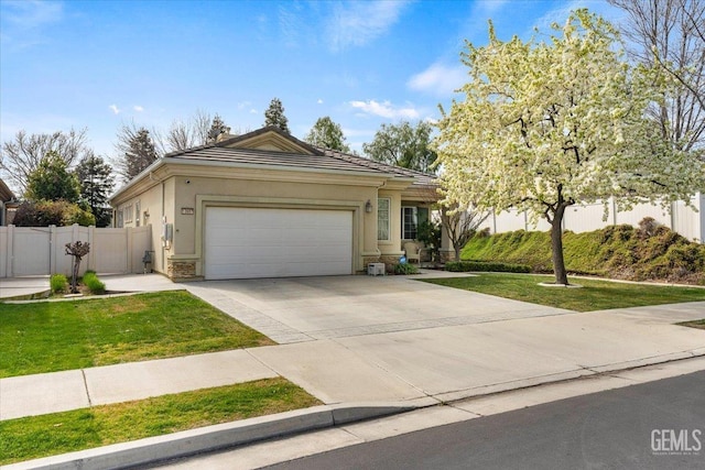 view of front of home with a garage and a front lawn