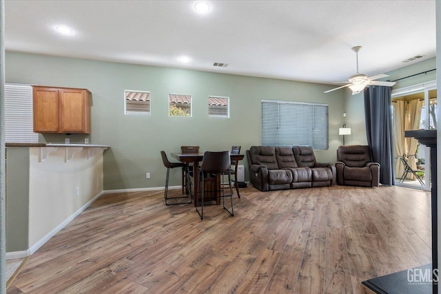 living room featuring hardwood / wood-style flooring and ceiling fan