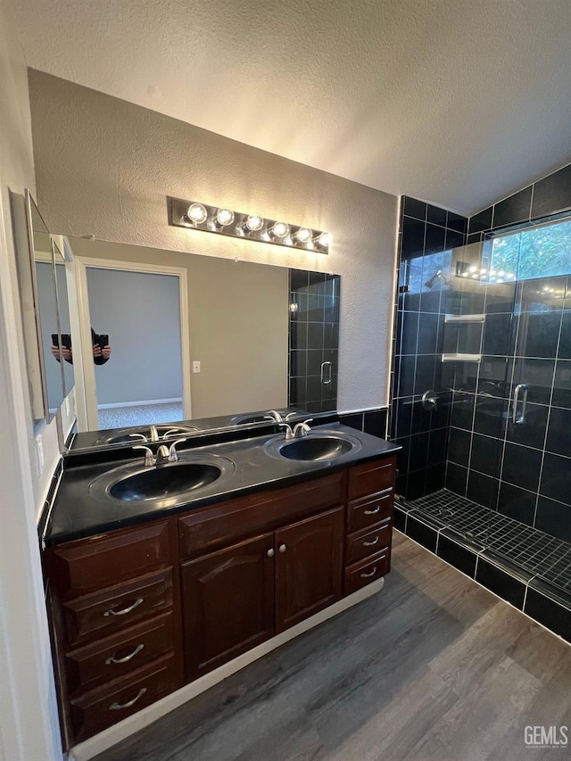 bathroom with lofted ceiling, vanity, a shower with door, and hardwood / wood-style floors