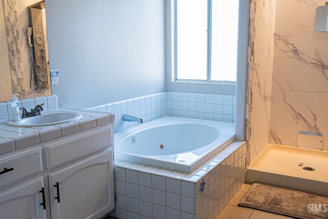 bathroom featuring tile patterned floors, vanity, and shower with separate bathtub