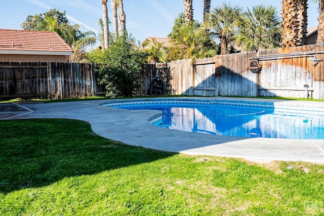 view of pool with a lawn