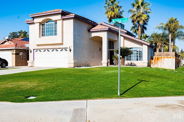 mediterranean / spanish-style home featuring a front yard and a garage