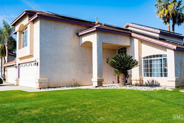 view of front facade featuring a front yard and a garage