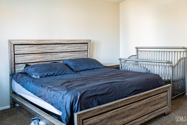 bedroom with dark colored carpet