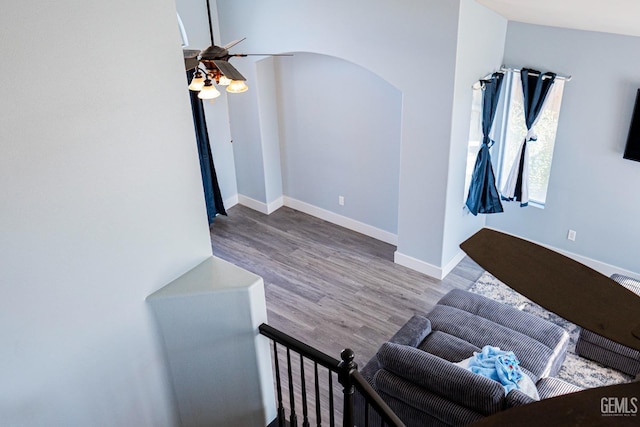 living room featuring ceiling fan and hardwood / wood-style flooring