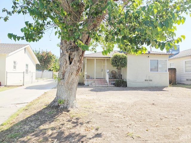 2313 Alturas Dr, Bakersfield, CA 93305 - view of front of home with covered porch, stucco siding, crawl space, and concrete driveway
