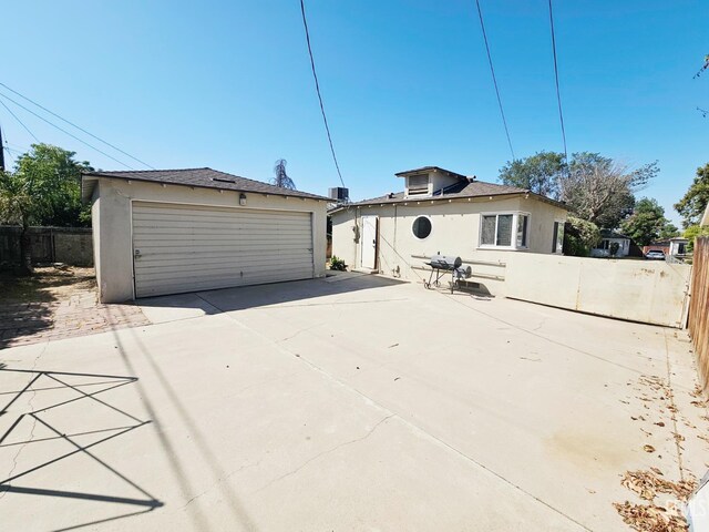 2313 Alturas Dr, Bakersfield, CA 93305 - back of property featuring a detached garage, stucco siding, and an outdoor structure