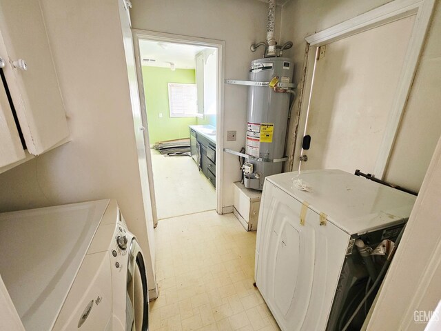 2313 Alturas Dr, Bakersfield, CA 93305 - laundry room with washing machine and clothes dryer, strapped water heater, and light flooring