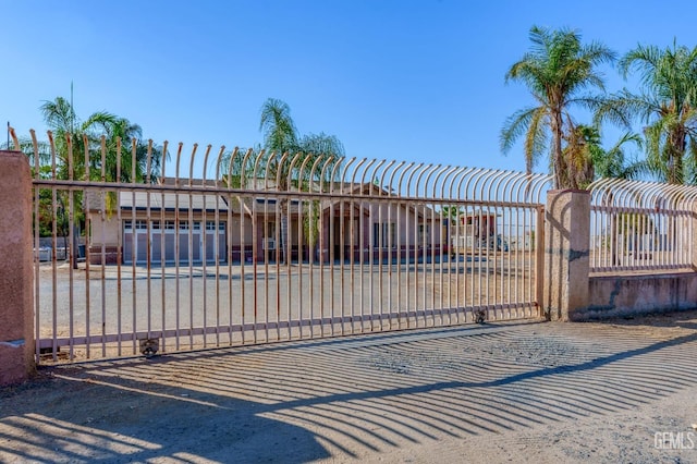 view of gate with a garage