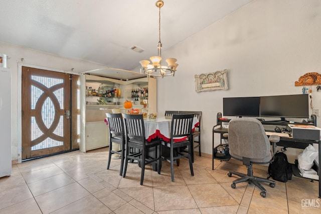 tiled dining space featuring an inviting chandelier