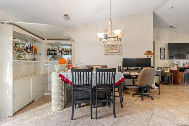 dining space with a notable chandelier, light tile patterned floors, and lofted ceiling