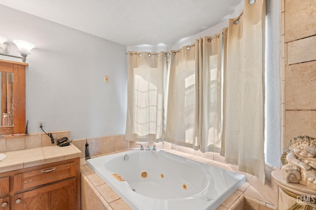 bathroom with vanity and a relaxing tiled tub