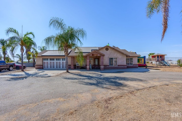 ranch-style home with solar panels