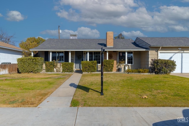 single story home featuring a garage, a front yard, and covered porch