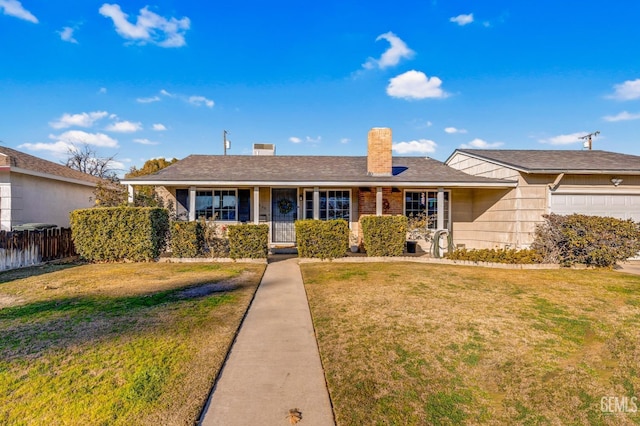 single story home featuring a front lawn and a garage