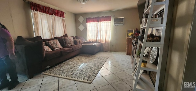 living room featuring light tile patterned flooring and a wall unit AC
