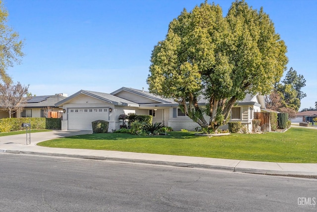 view of front of property with a garage and a front lawn