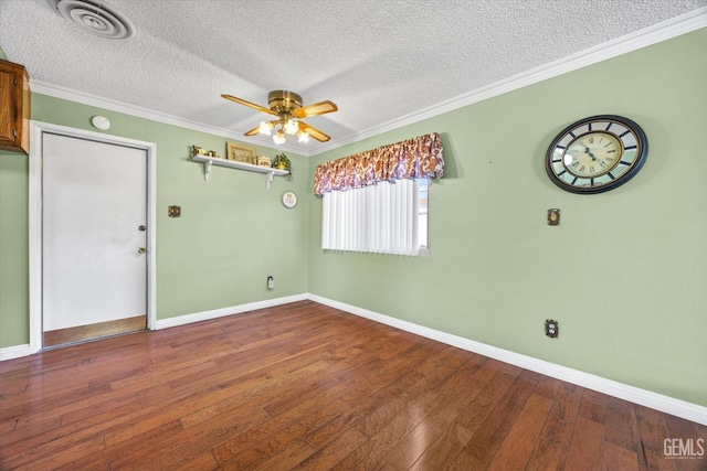 spare room featuring hardwood / wood-style floors, ceiling fan, ornamental molding, and a textured ceiling