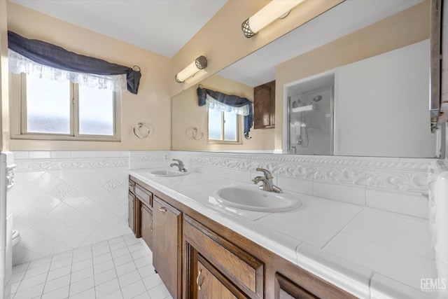 bathroom featuring tile patterned flooring, a wealth of natural light, vanity, and tile walls