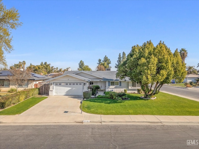 ranch-style home with a front lawn and a garage