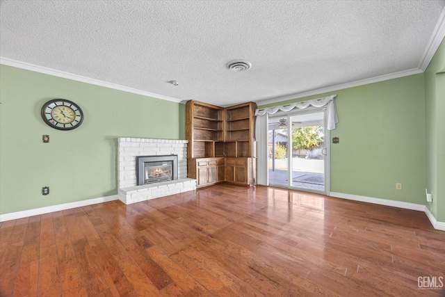 unfurnished living room featuring crown molding, a fireplace, a textured ceiling, and hardwood / wood-style flooring