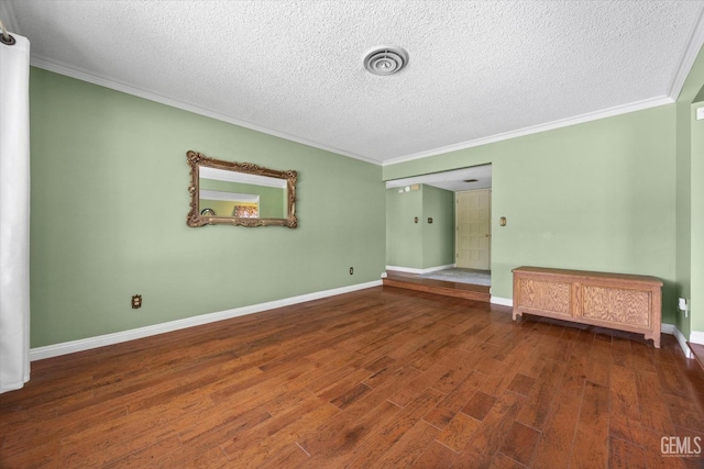 unfurnished room with dark wood-type flooring, a textured ceiling, and ornamental molding