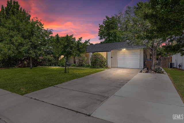 808 La Puente Dr, Bakersfield, CA 93309 - view of front of house featuring an attached garage, a front yard, concrete driveway, stucco siding, and cooling unit