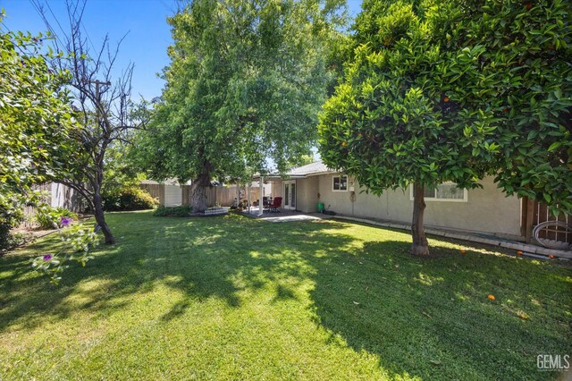 808 La Puente Dr, Bakersfield, CA 93309 - view of yard with a patio, a storage unit, and an outdoor structure