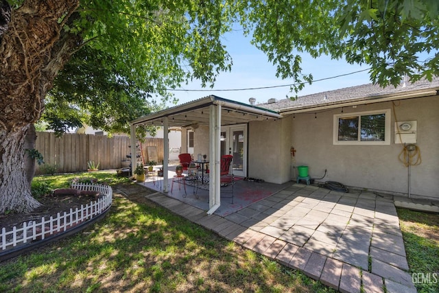 808 La Puente Dr, Bakersfield, CA 93309 - back of property with stucco siding, a fenced backyard, a patio area, and french doors