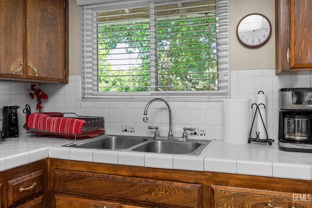 808 La Puente Dr, Bakersfield, CA 93309 - kitchen featuring a sink, backsplash, and tile countertops